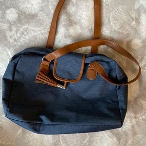 Denim shoulder bag with inside zip storage.